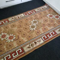 گلیم فرش و ساعت دیواری