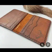 کیف پول قهوه‌ای روشن با مدارک بنام حسینی گمشده