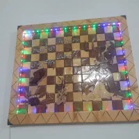 تابلو چوبی معرق کاری طرح دست لامپ نوری دارد