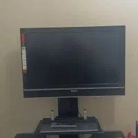 تلویزیون سونی به همراه میز و دستگاه دیجیتال