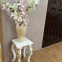 گل و گلدان به همراه میز چوبی چهار پایه