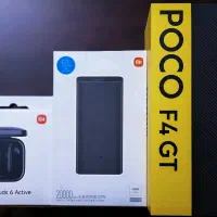POCO F4 GT با پاوربانک و هندزفری.