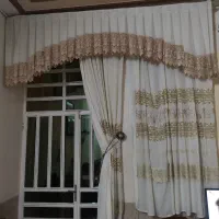 پرده کلاسیک مجلسی با طرح گل‌دار طلایی و کرم