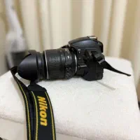 دوربین عکاسی Nikon D3100 + لنز VR + کوله‌پشتی
