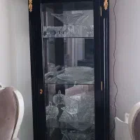 بوفه چوبی مشکی طلایی پشت اینه و سه طرف شیشه