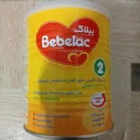 قوطی شیرخشک همراه درب. زرورق. پیمانه. و آب معدنی