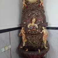 ساعت کنارسالنی آبنمادرارطرح آدم وحواوفرشته