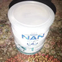 قوطی خالی شیر خشک با پیمانه و درب