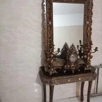 آیینه و کنسول و شمعدان و ساعت
