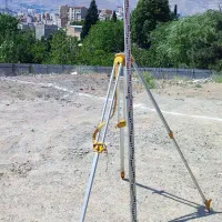 سه پایه نقشه برداری و خط کش تی
