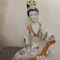 دوتا مجسمه عروس نشسته روی صندلی
