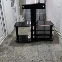 میز تلویزیون شیشه‌ای مشکی تمیز و سالم